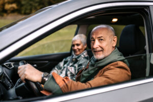 Senior couple of adventurers in car, going on a road trip